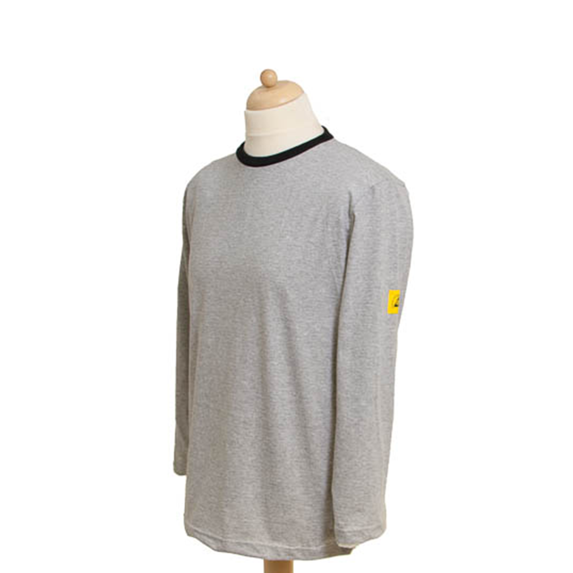 Grijs ESD-longsleeve shirt met ronde hals, donkere boordafwerking aan hals, en een geel ESD-logo op de mouw, voor gebruik in elektrostatisch gevoelige werkomgevingen. T-shirt à manches longues ESD gris à col rond, avec bordure foncée au niveau du col et logo ESD jaune sur la manche, destiné à être utilisé dans des environnements de travail sensibles aux charges électrostatiques.